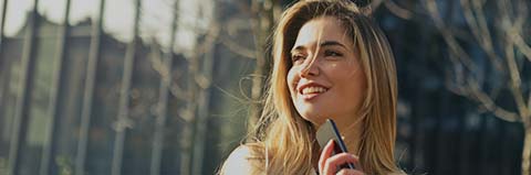 Real estate professional speaking by phone outside a residential property