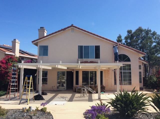 Completed patio cover and full exterior repaint on a two-story San Diego home